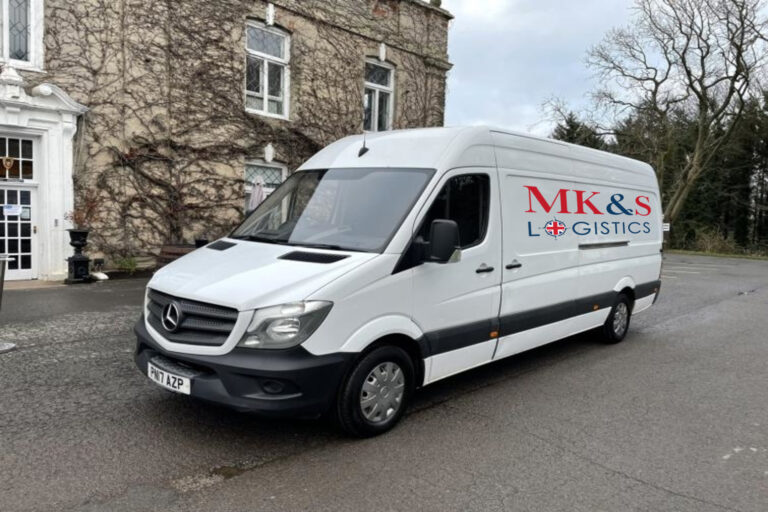 MK&S Logistics van in front of stately building